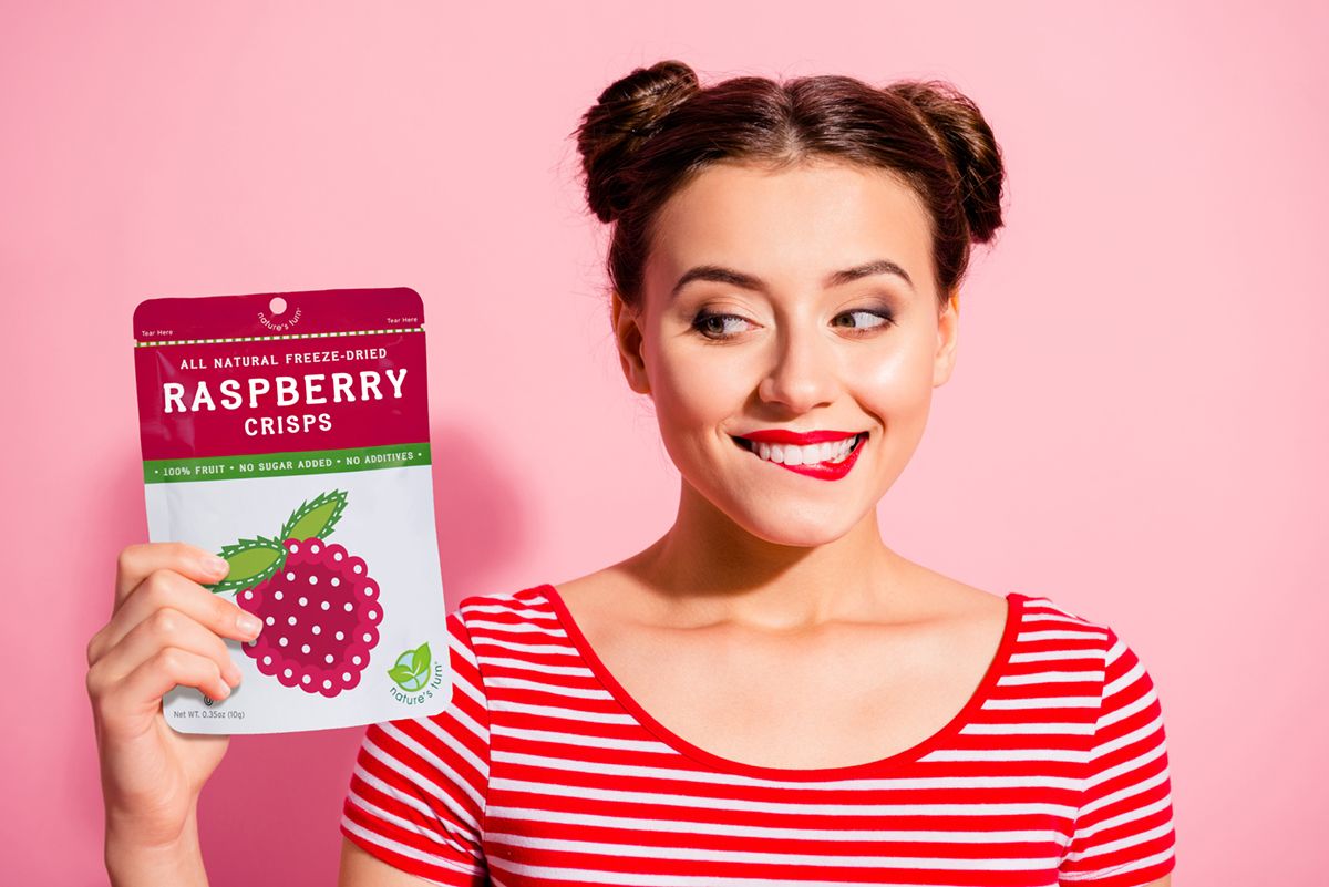 Woman holding raspberry treats